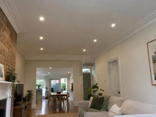 Living room ceiling with recessed downlights in a brick and plaster home interior in North Sydney