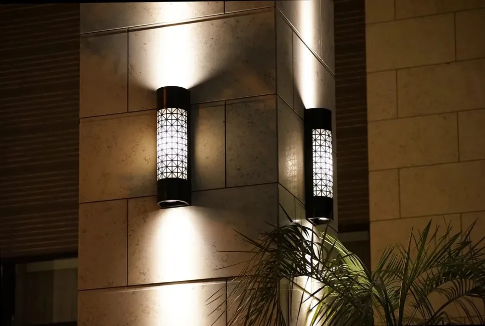 Exterior wall lights on a rendered facade at night