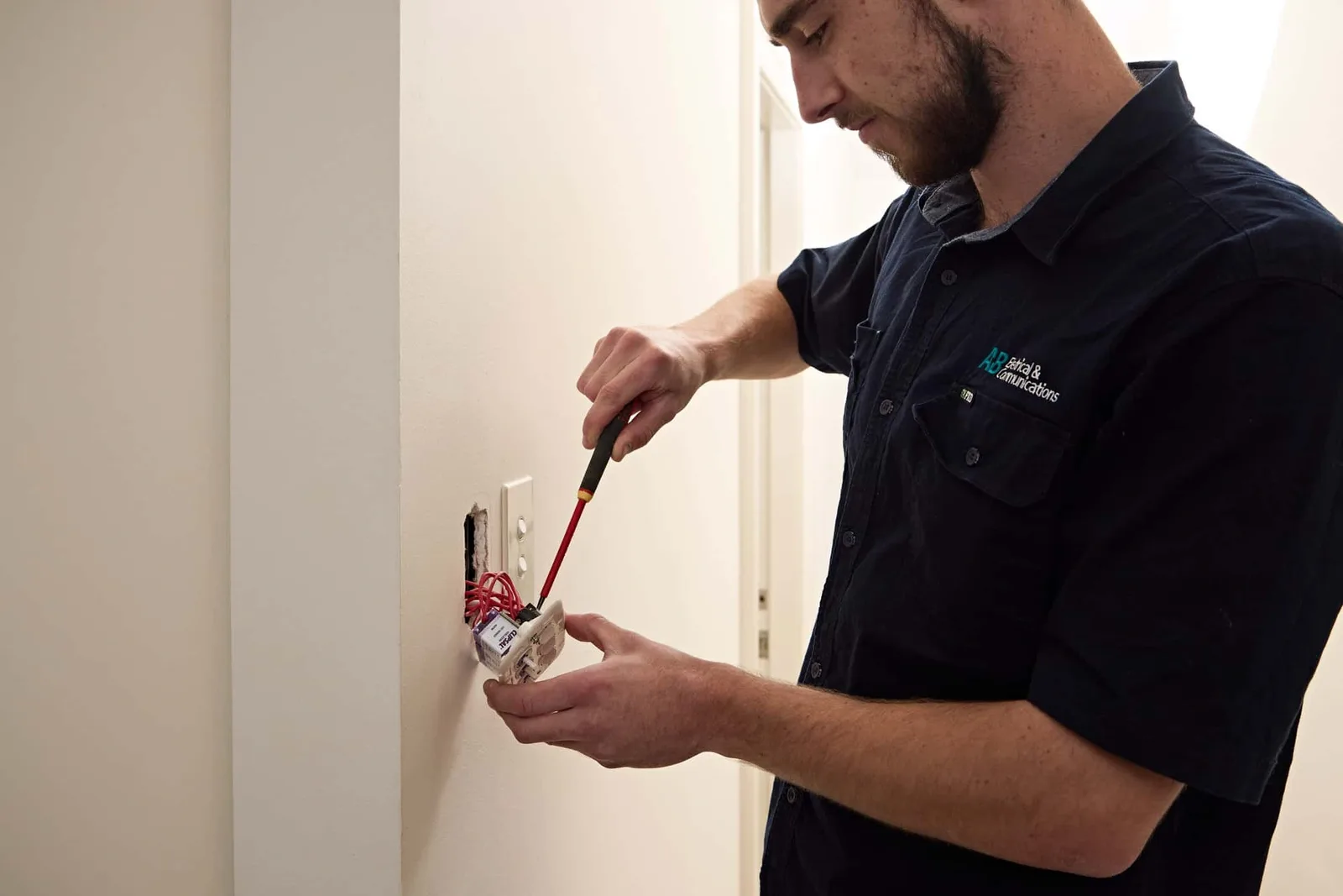 Electrician installing a wall power point