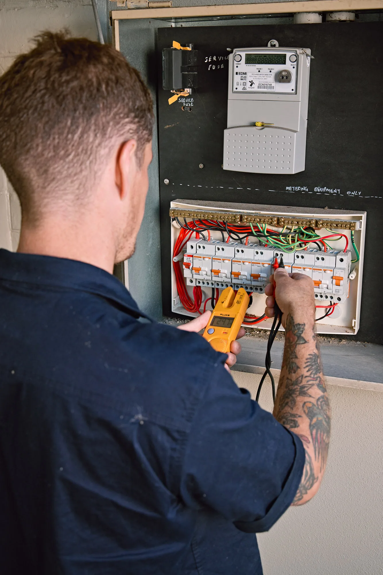 Licensed electrician fault-testing a home switchboard