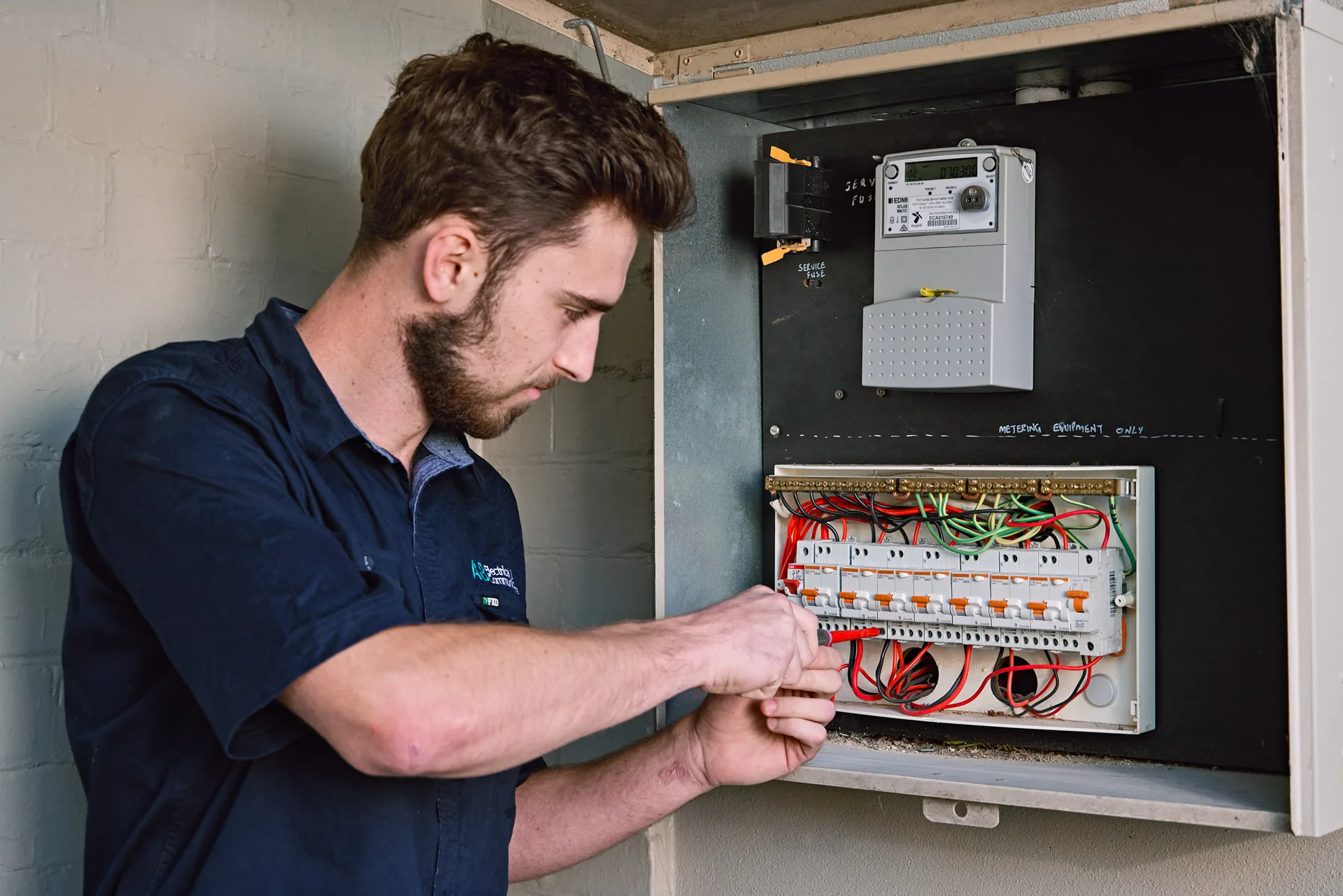 Licensed electrician working through a switchboard rewire